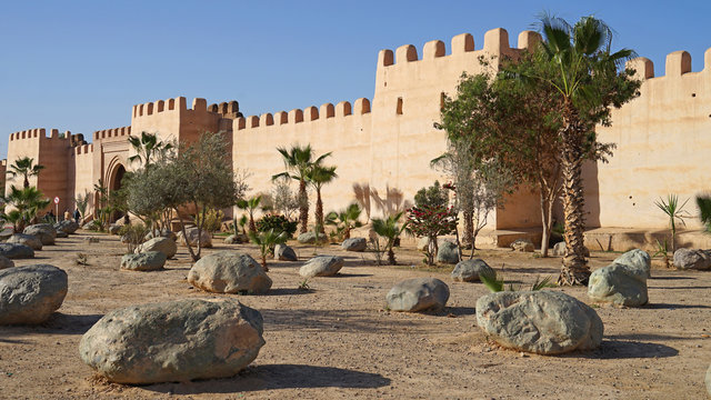 Old Berberian town defensive wall with gate and park with palm trees, Taroudant, Morocco
