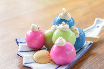 Fototapeta na wymiar Mochi of Japanese dessert is cute and tasty colorful on wood table