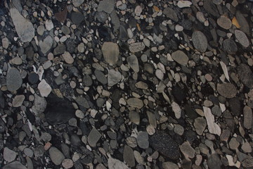 Natural granite with different pebbles of black and gray shades of color frozen in it is called Nero Marinace