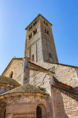 Fototapeta na wymiar View of the bell tower and apses of the Romanesque church of Chapaize, France