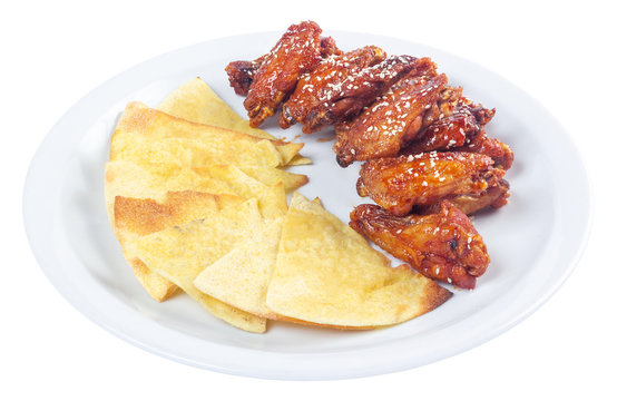 chicken wings in spicy sauce. popular pub dish. beautiful junk food concept. isolated on a white plate.