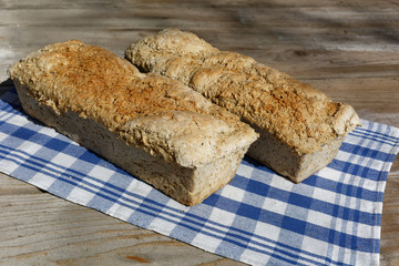 Homemade loaf of bread on kitchen cloth. Traditional handmade bread. Home baking.