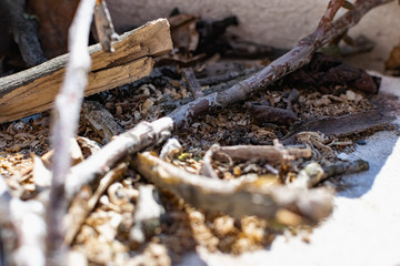 Small twigs and dry chips on a concrete background , lying in a pile under the open sky for a small fire