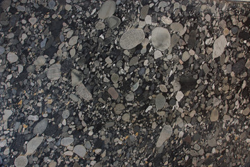 Natural Brazilian granite with pebbles in black and gray shades called Nero Marinace