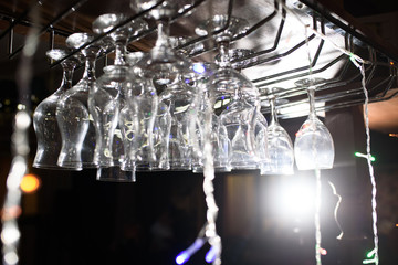 Empty wine glasses in a restaurant that flash highlights. Dishes for alcoholic beverages.