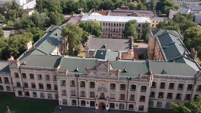 Aerial view Polytechnic Institute in Kiev in the summer. People walk near the institute At the top of the building, the flag of Ukraine is developing