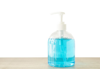 A bottle of blue medical alcohol gel on brown wooden table, die cut isolated with clipping path on white backgrounds, product for prevention from corona virus, bacteria and germs