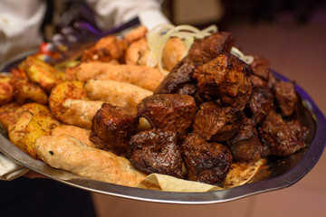 Delicious juicy kebab for guests in the restaurant. A lot of tasty meat.