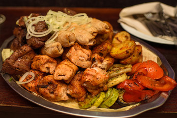 Delicious juicy kebab for guests in the restaurant. A lot of tasty meat.
