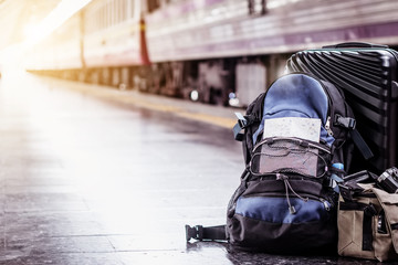 Solo woman backpacker traveler plan safety trip low cost budget summer holiday after coronavirus. Empty tourist on train railway platform. Use bus train sustainable environmental friendly transport
