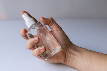 Hand of lady that applying alcohol spray or anti bacteria spray to prevent spread of germs, bacteria and virus. Personal hygiene concept. Sanitizer