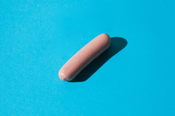 Sausage on a blue background isolate with hard light