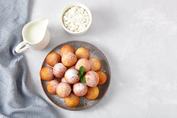 Beautiful breakfast. Cottage cheese donuts  balls  on a light background.