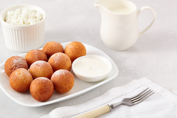 Beautiful breakfast. Cottage cheese donuts  balls  on a light background.
