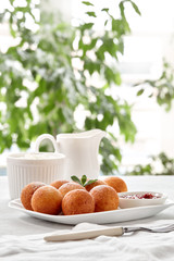 Beautiful breakfast. Cottage cheese donuts  balls  on a light background.