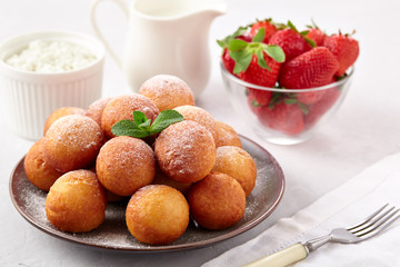 Beautiful breakfast. Cottage cheese donuts  balls  on a light background.