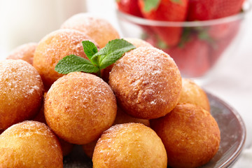 Beautiful breakfast. Cottage cheese donuts  balls  on a light background.