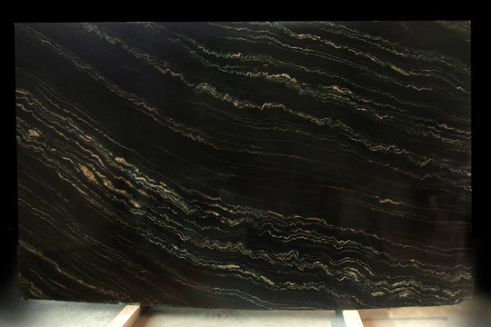 A slab of natural stone in black marble with yellow stripes is called Quarzite Portoro Gold