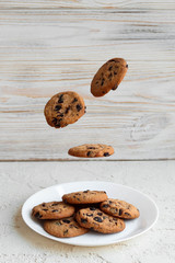 Flying American cookies with chocolate crumbs, homemade delicious cookies vertical photo