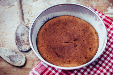 homemade crispy cake, baked in the electric oven during the pandemic quarantine period on the wooden work table
