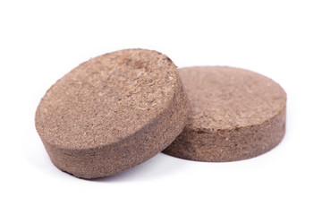 Dry peat pellets, compressed compost tablet