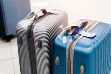 Baggage traveler reclaimed and Cancel flights stop and prevent COVID-19 virus disease. Silver and blue travel bag suitcase in airport that restrict traveling to stop world pandemic COVID-19