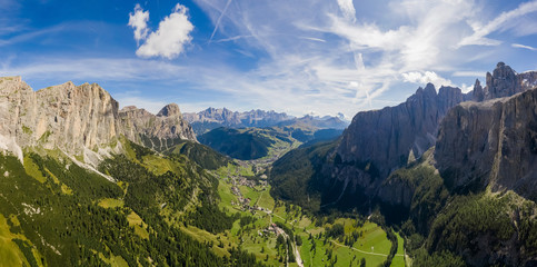 Serpentine in the Italian Alps mountains. Gardena pass,Passo Gardena, Rifugio Frara, Dolomiti, Dolomites, South Tyrol, Italy, UNESCO World Heritage. Aerial amazing shot. View from above.