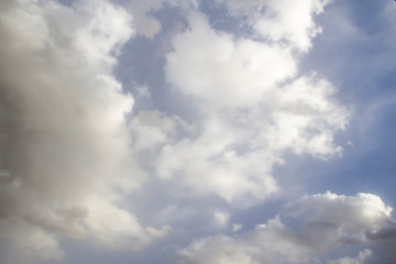 Clouds in the blue sky. A stunning gray sky. The storm is approaching. A beautiful clouds against the blue sky background. Amazing cloud pattern in the sky.