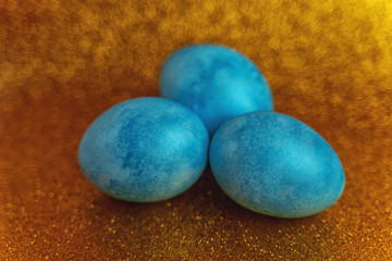 Blue golden egg on a shiny gold background