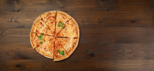 cheese pizza top view on dark wood table
