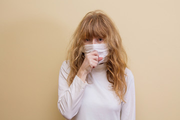 woman with medical mask on her face coughing and catarrh. virus and infection prevention