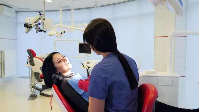 Female dentist doing dental treatment to her patient in clinic