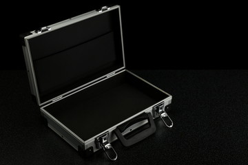 aluminum suitcase on a black background. stylish aluminum case on a dark background with copy space