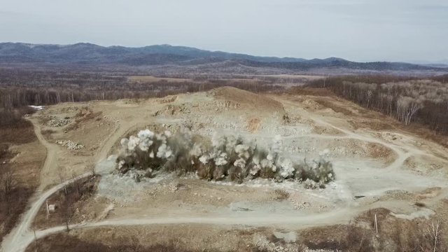Blast in open cast mining quarry .