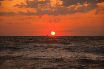 Natural background for text and sand and sea waves. Footprints in the sand from the legs go into the distance. Summer, sea, sunrise.