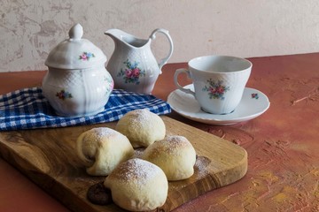 .chocolate filled cookies on colored background with teapot and cup