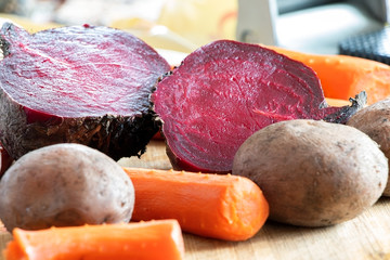 Cooked, boiled vegetable on a cutting board. Carrot, potatoes and beet. Beetroot.