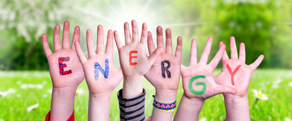 Children Hands Building Colorful Word Energy. Green Grass Meadow As Background