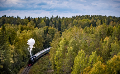 Old soviet steam locomotive passing though Karelian forrest