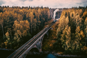 Old soviet steam locomotive passing though Karelian forrest