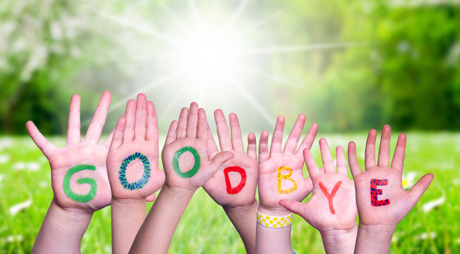 Children Hands Building Colorful Word Goodbye. Green Grass Meadow As Background