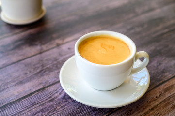 Hot coffee americano on the old wooden table
