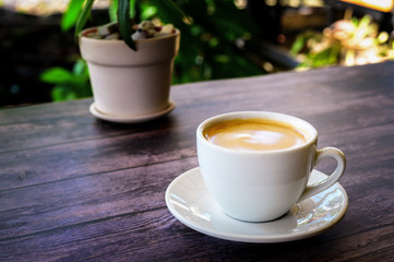 Hot coffee americano on the old wooden table