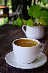 Hot coffee americano on the old wooden table