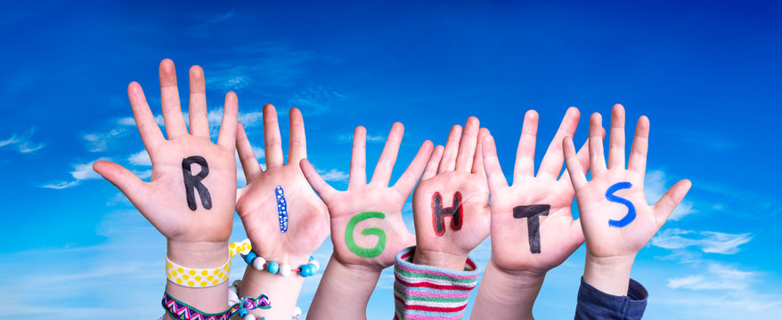 Children Hands Building Colorful English Word Rights. Blue Sky As Background