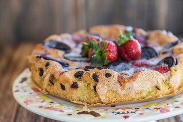 chocolate and strawberry cake on the wooden background