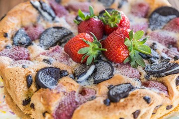 chocolate and strawberry cake on the wooden background