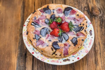 chocolate and strawberry cake on the wooden background