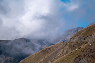 A off-road car is park in front of a landscape view of caucasus mountains in Georgia