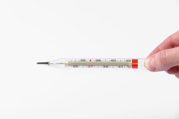 Human hand holding medicine healthcare thermometer. glass thermometers in hand.